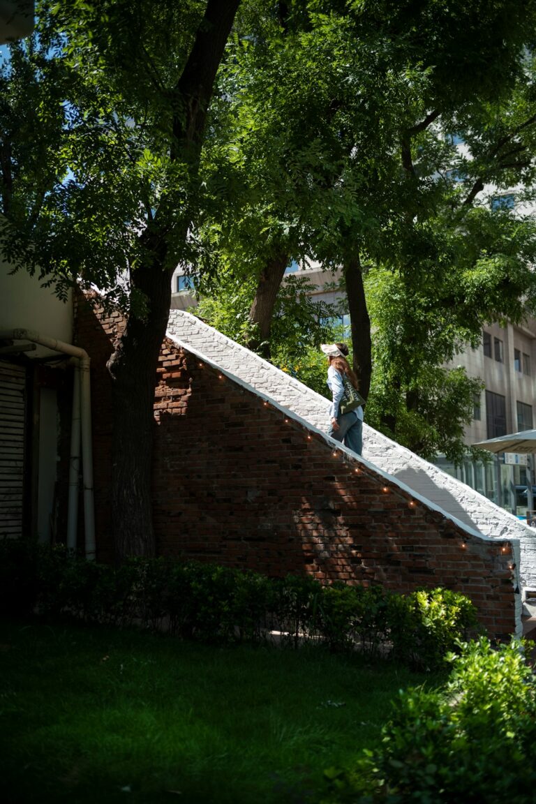 Person in slip-resistant boots carefully stepping across a dry sloped shingle roof while avoiding a skylight.